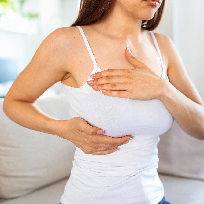 a woman doing breast self-examination (BSE)
