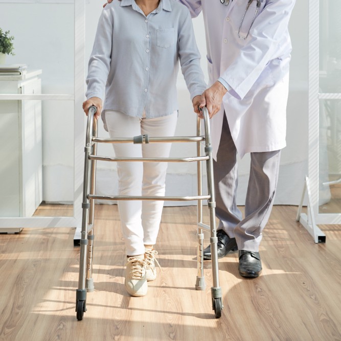 doctor assisting patient walk with mobility