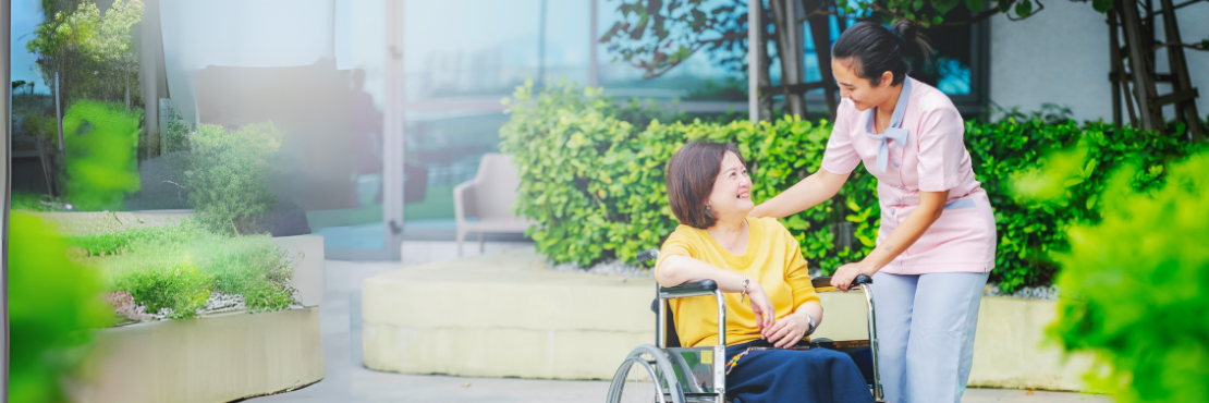 Nurse chatting with patient that on a wheelchair