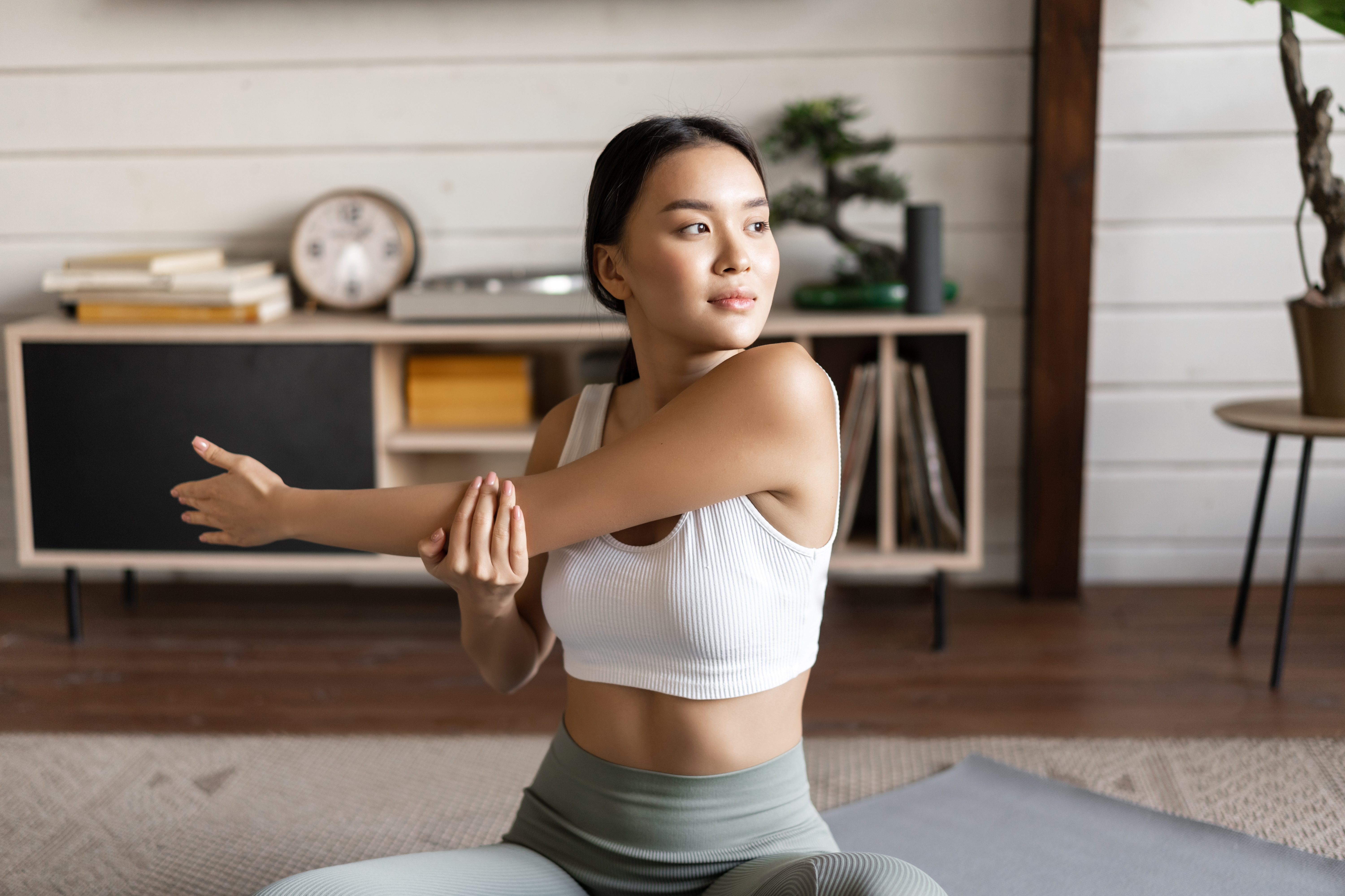 woman doing workout and stretching on a yoga mat