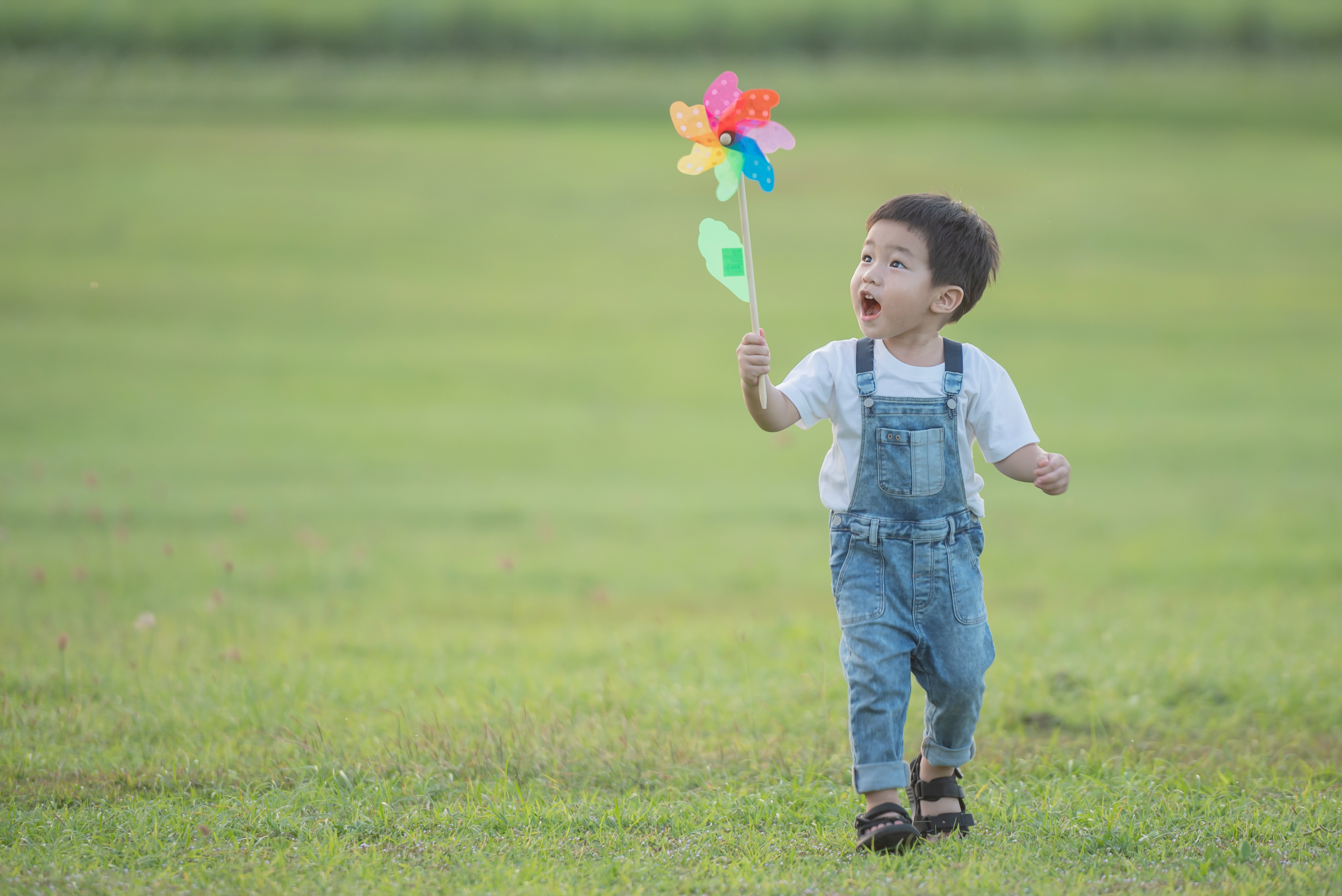 asian children playing colourful windmill