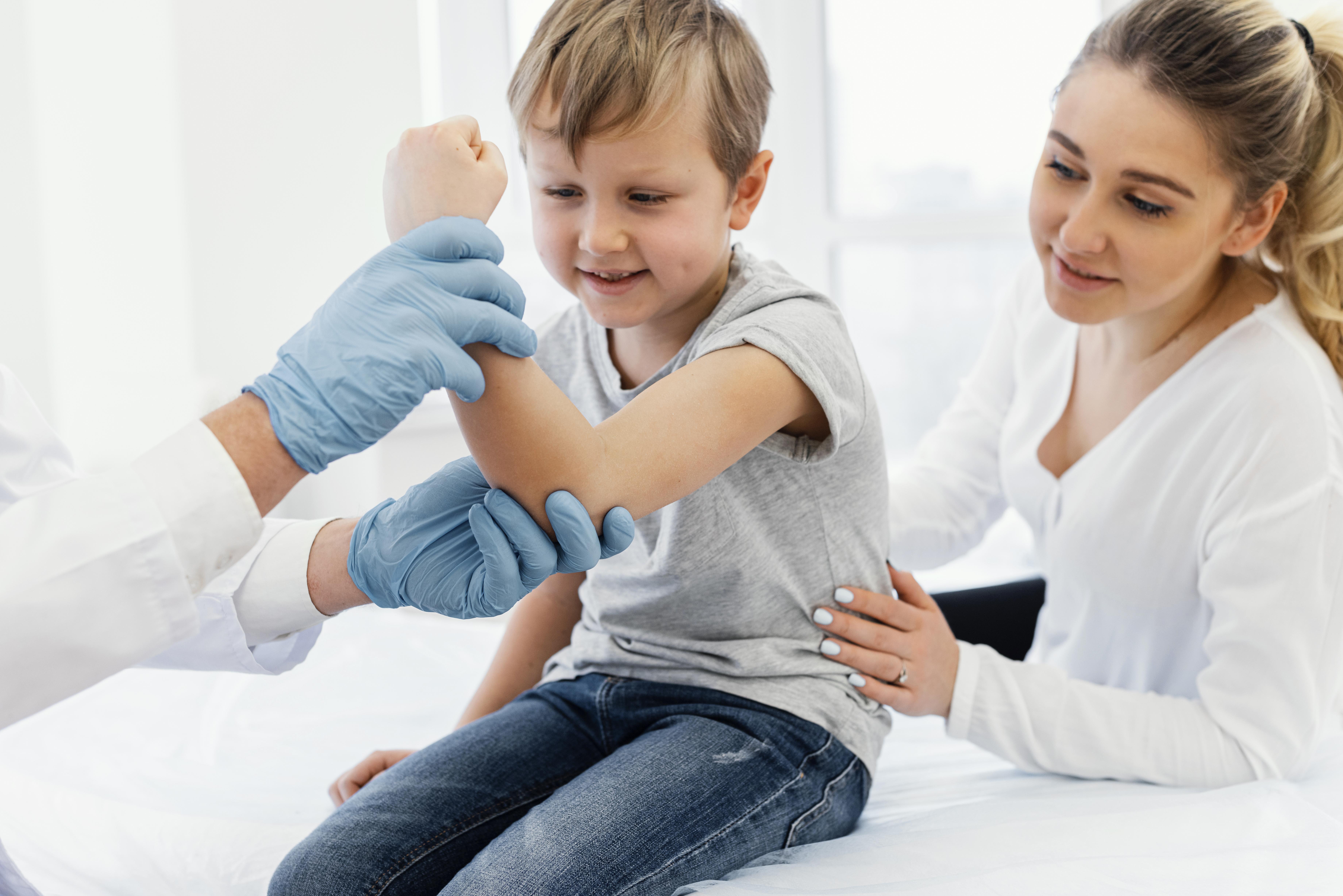 close up of doctor holding kid's arm