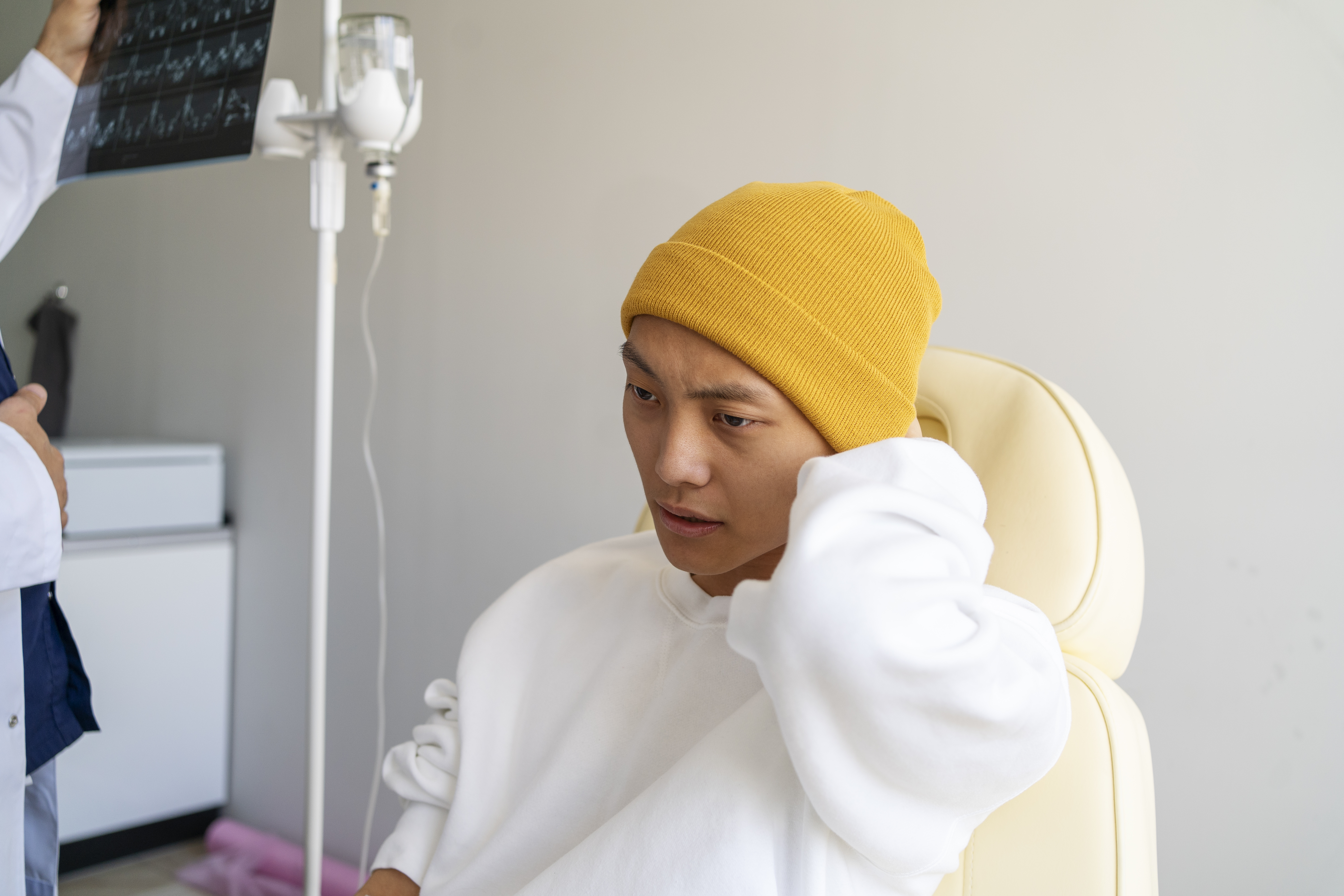 asian cancer patient sitting on chair