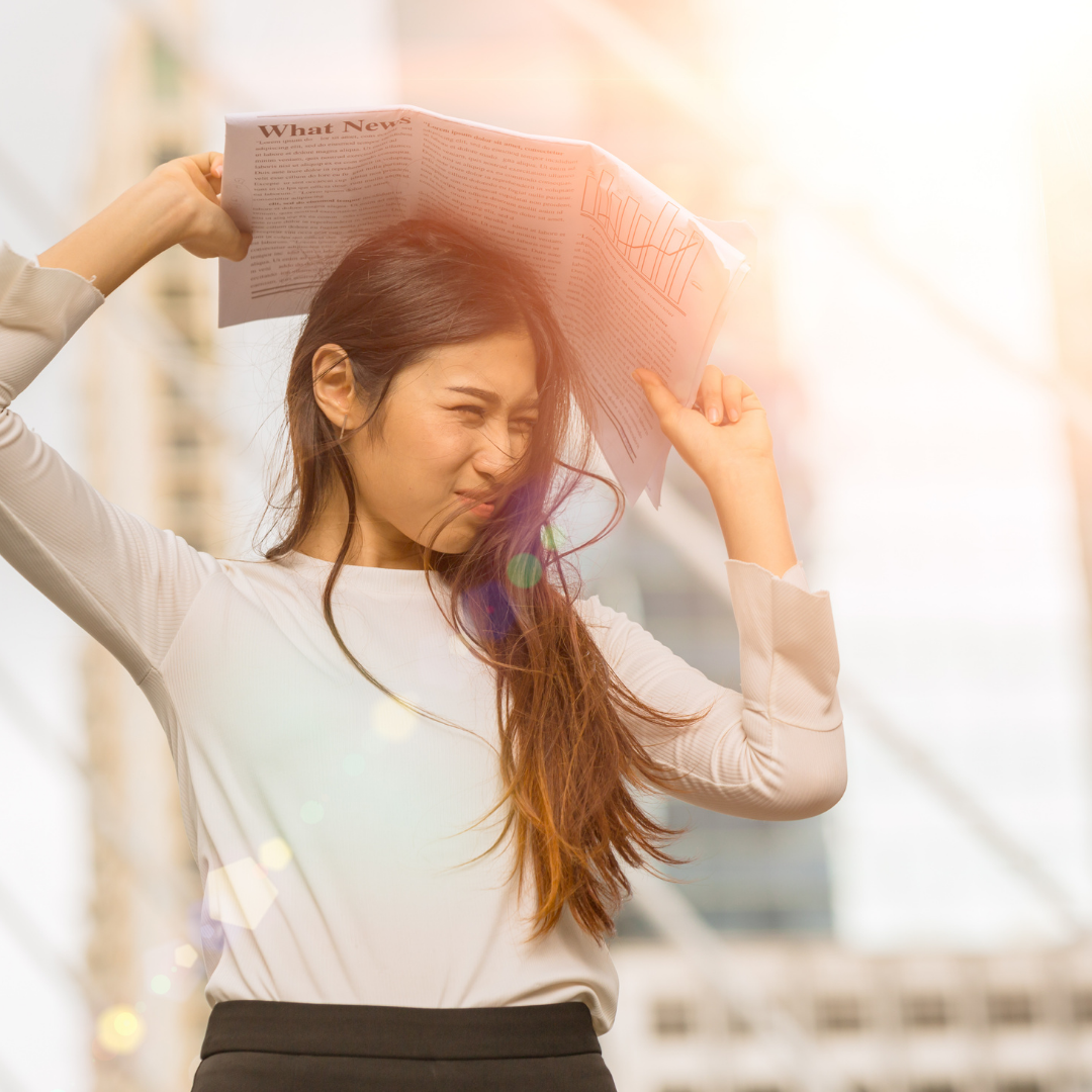 Women use news paper to block sun light