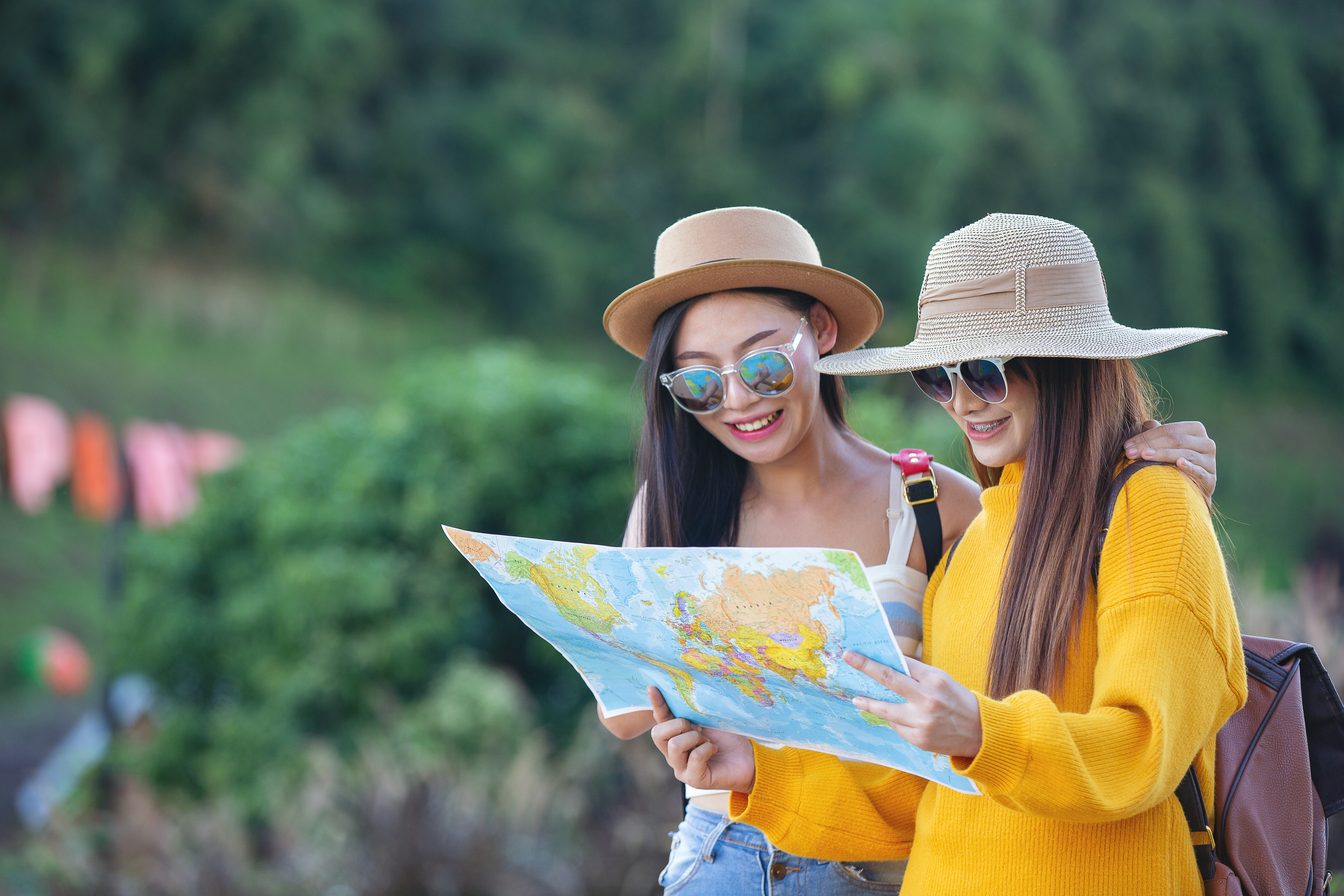 two female tourists holding map