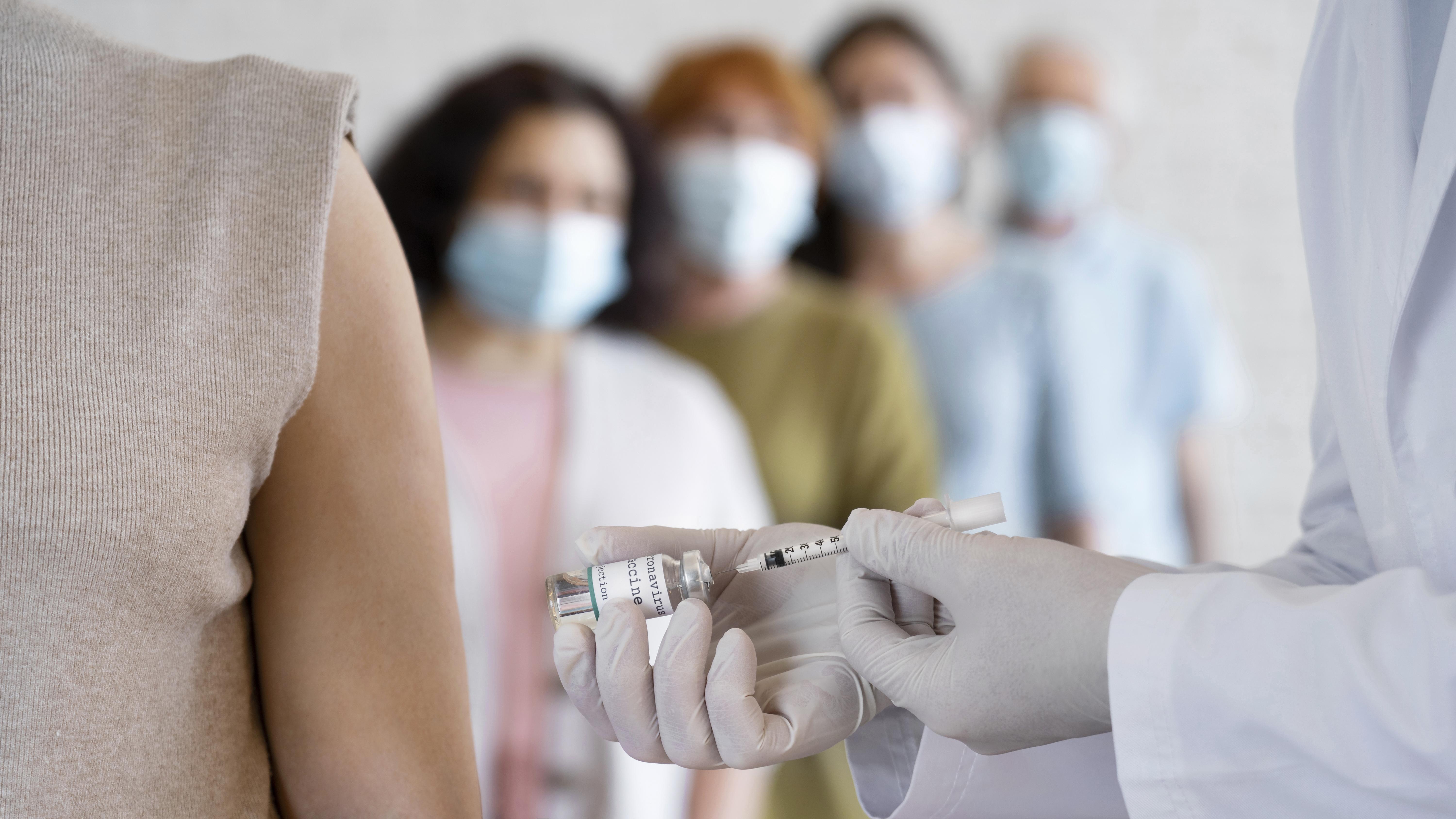 Women Getting Vaccine Shot By Doctor